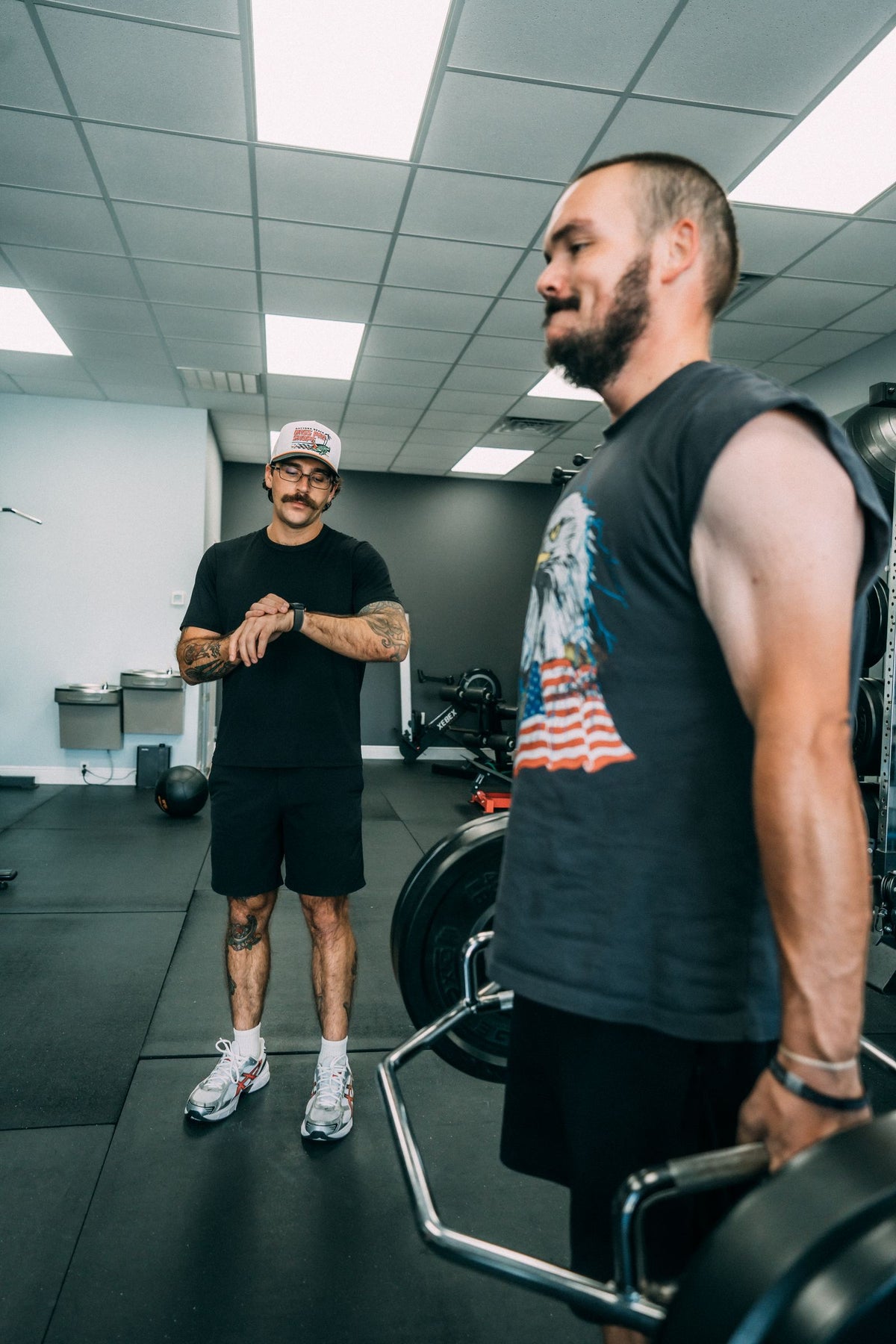 Personal trainer coaching deadlift form one-on-one in a Melbourne, FL studio