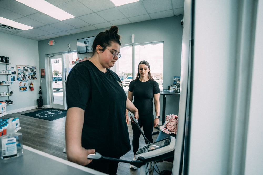 Client stepping on the InBody body composition scanner with a coach