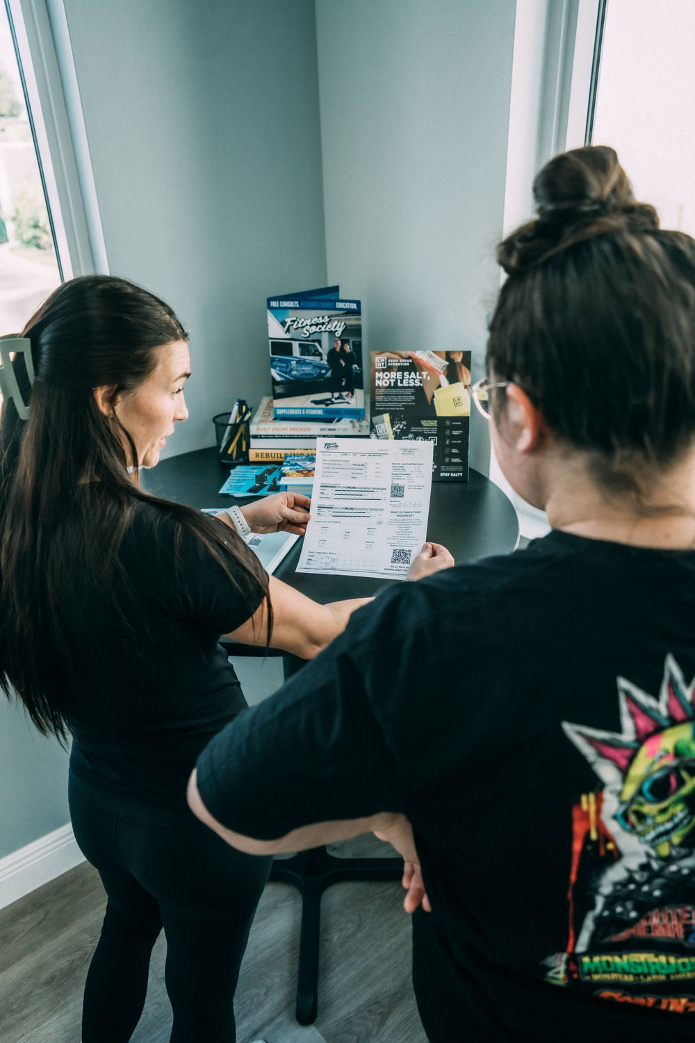 Client and coach going over InBody numbers at the studio desk
