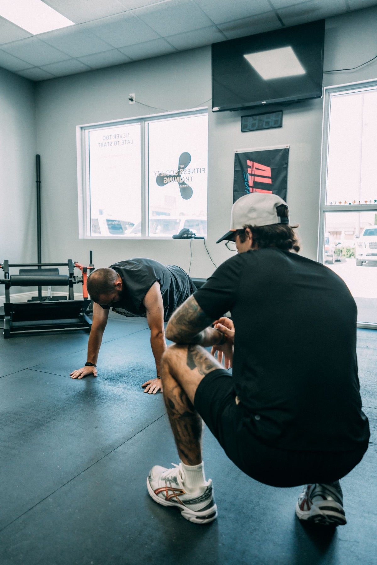 Coach guiding a mobility drill on the studio floor