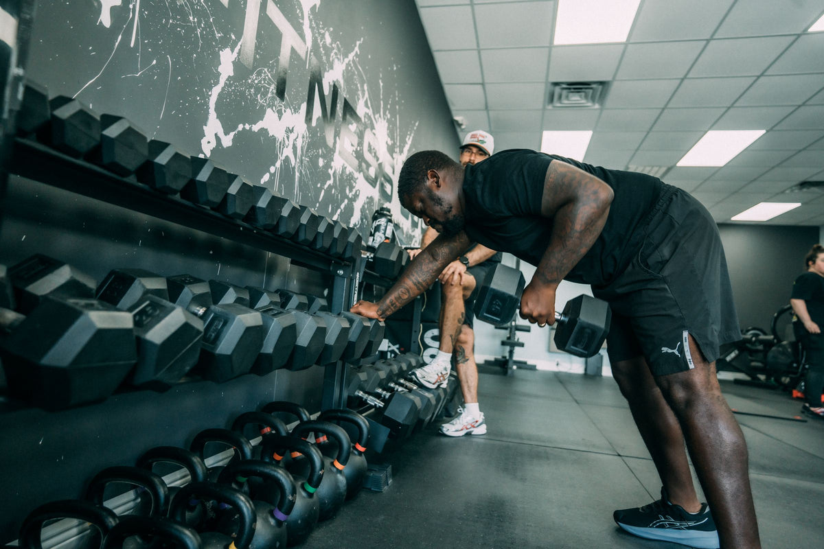 Client picking up dumbbells from the rack during a session